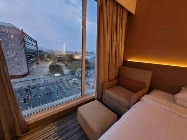 Cozy hotel ballroom with large window and outdoor event space, ideal for gatherings.