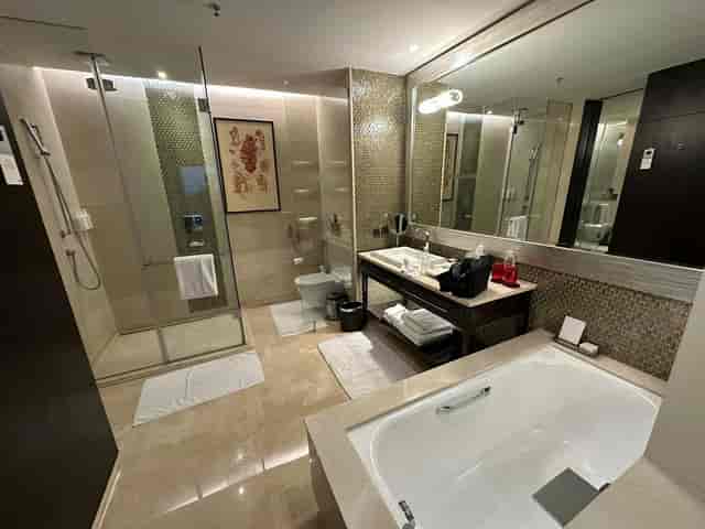 Luxurious hotel bathroom with spacious shower in JW Marriott Bengaluru, perfect for events.