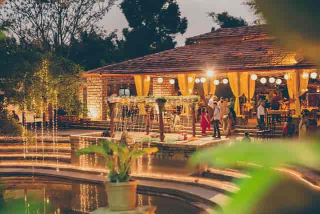 Outdoor wedding venue with rustic architecture and lush greenery at The Tamarind Tree.