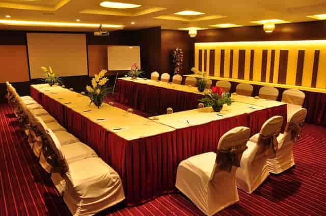 Meeting hall at The Arcadia Hotel with U-shaped table, elegant decor for conferences.