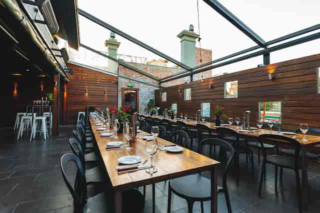 Lounge Bar at Arcadia Hotel with elegant table setup for corporate dinners and gatherings.