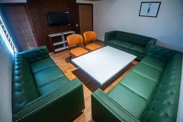 Modern Arcadia Hotel Board Room with green leather couches for meetings and workshops.
