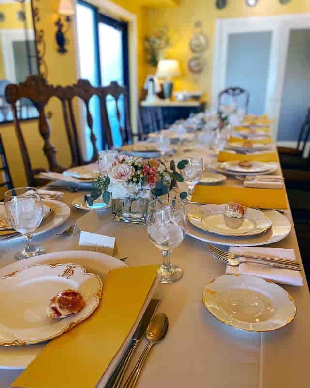 Elegant dining setup with floral centerpiece for a restaurant buyout event at Arcadia Farms Café.