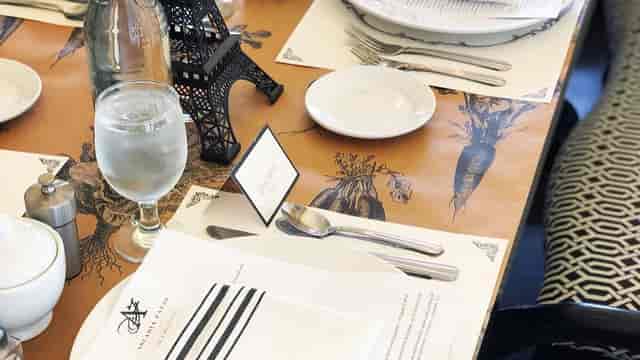 Elegant table setting with Eiffel Tower centerpiece for corporate event at Arcadia Farms Café.