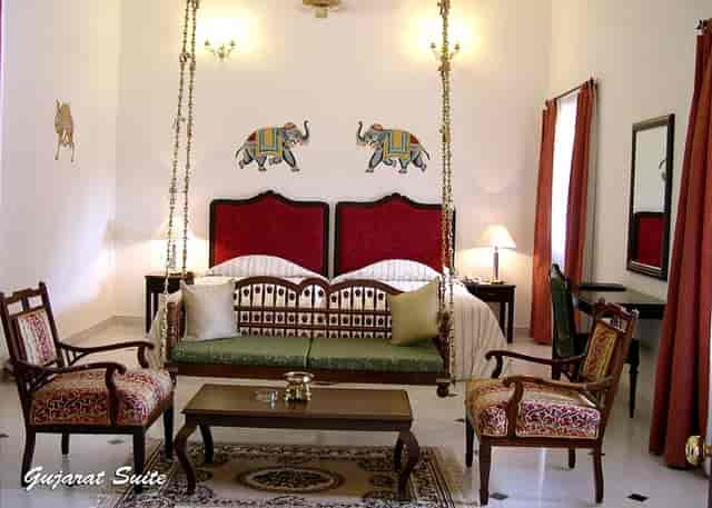 Luxury suite at Jayamahal Palace, elegant decor for meetings and retreats.