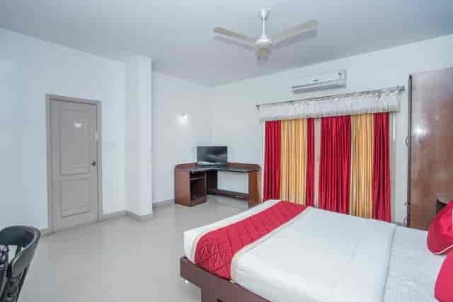 Eco hotel suite with comfortable bed, perfect for conference attendees and events.