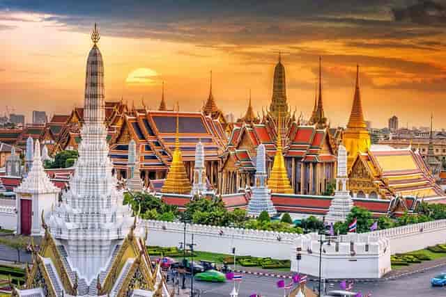 Grand Palace sunset with ornate spires, perfect for cultural events or gala dinners.