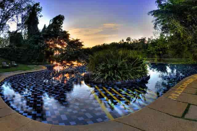 Chikkana Halli Estate poolside venue with sunset for elegant cocktail receptions and gatherings.