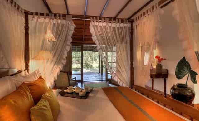 Luxurious bedroom at Evolve Back Palace Suites for wellness events and meetings.