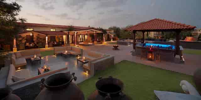 Elegant outdoor event space at The Royal Retreat Resort & Spa with cozy lounge areas.