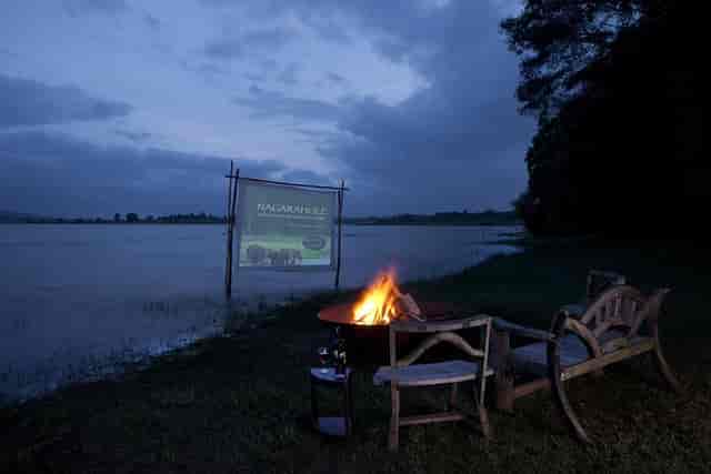 Outdoor event setup with fire pit and projection screen at Waterwoods Lodge.