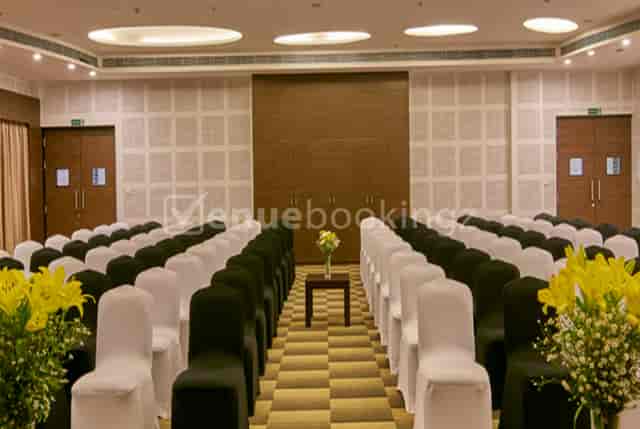 Elegant banquet hall with black and white chair covers, perfect for meetings or ceremonies.