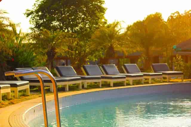 Private pool at Mango Mist Resorts with lounge chairs, ideal for outdoor events and gatherings.