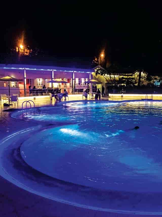 Vibrant outdoor fitness centre with illuminated pool, perfect for evening cocktail events.