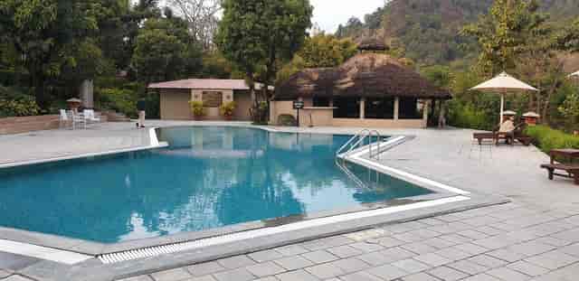 Lawn by pool at The Riverview Retreat, ideal for networking events and relaxation.