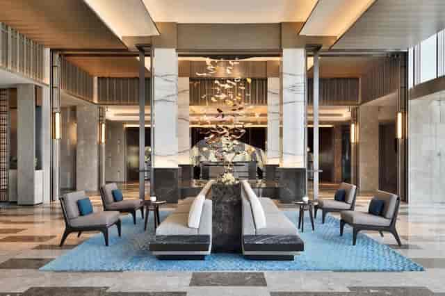 Elegant Banquet Hall with tranquil water feature at JW Marriott Bengaluru for events.