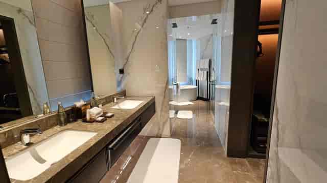 Modern hotel bathroom with dual sinks at JW Marriott Bengaluru for upscale events.