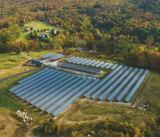 Community solar farm in Arcadia with autumn foliage, ideal for eco-friendly retreats.