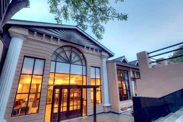 Elegant resort hotel in Chinar Pahalgam with large windows, perfect for events.