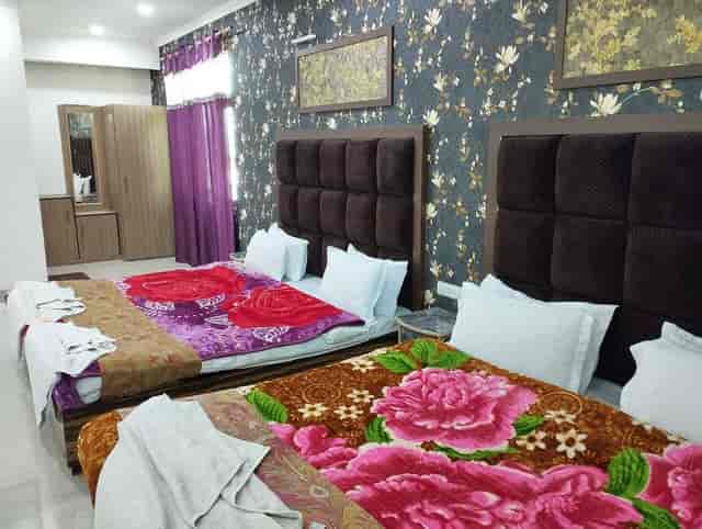 Classic Suite at Triden Kashmir Resort with two beds, perfect for event relaxation.