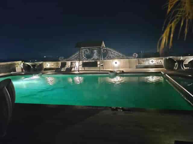 Elegant rooftop banquet hall with serene pool for upscale evening events and gatherings.