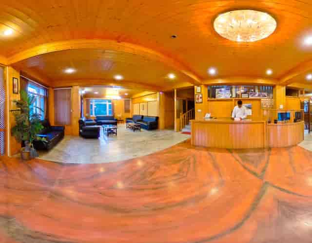 Welcoming hotel lobby with wooden accents, ideal for conferences and networking events.