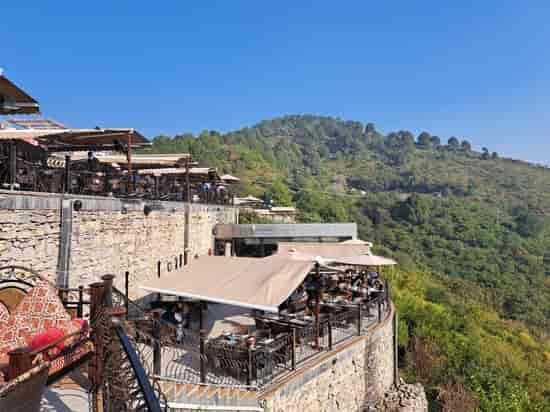 Rooftop dining at The Monal with lush greenery, perfect for events and gatherings.