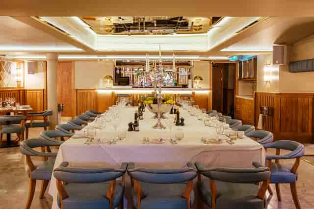 Elegant private dining room with long table, perfect for corporate dinners and events.