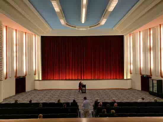 Main Auditorium at Regal Theatre with grand stage and red curtains for events.