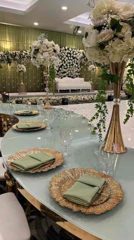 Elegant banquet hall setup with round table, greenery, perfect for upscale events.