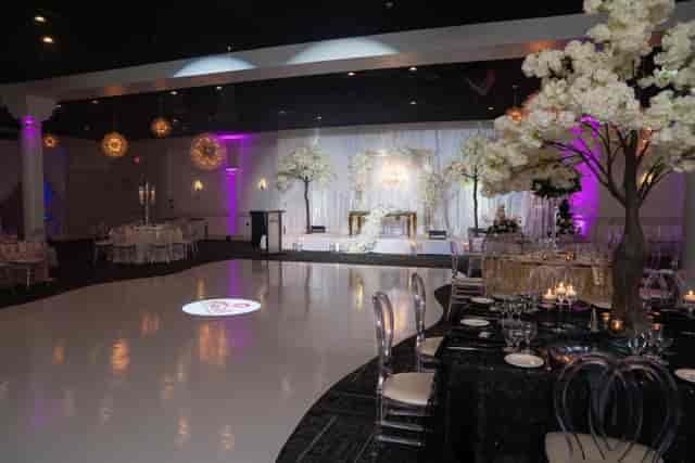 Elegant Oasis Ballroom setup for weddings with floral decor and polished dance floor.