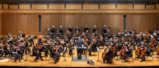 Orchestra performing in Saffron Hall auditorium for live music event.