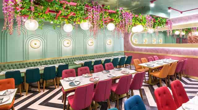 Intimate event space in Lahore Karahi with colorful seating for dining and networking.