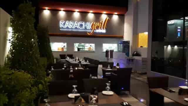 Outdoor dining at Karachi Grill with elegant tables and greenery for events.