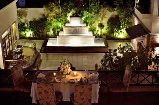 Elegant Sultan Boardroom dining area for upscale events, featuring serene fountain views.