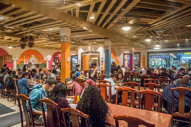 Lahore Tikka House bustling restaurant with vibrant decor, ideal for social events.