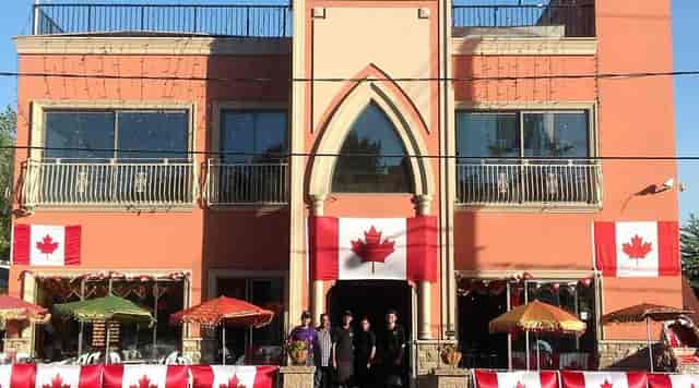 Lahore Tikka House with Canadian flags, ideal for summer events and festivals.
