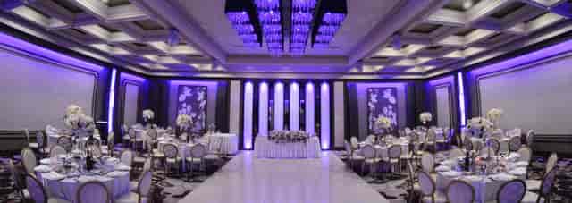 Elegant banquet hall with chandeliers, perfect for weddings and corporate events.