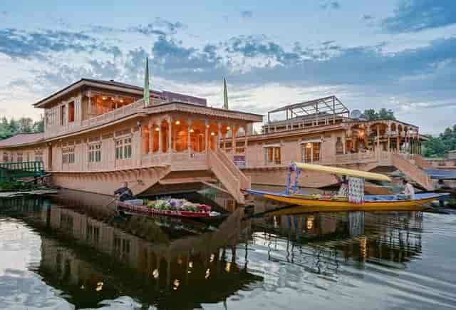 Traditional houseboat on tranquil waters, perfect for luxury events and retreats.