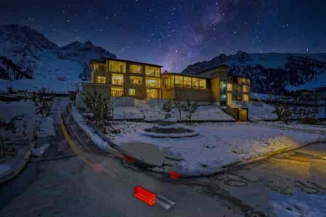 Super Delight venue in Snowland Resorts: modern architecture under a starry sky for winter events.