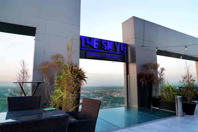 Sophisticated rooftop meeting room "The Skye" at Indigo Hotel with city skyline for events.