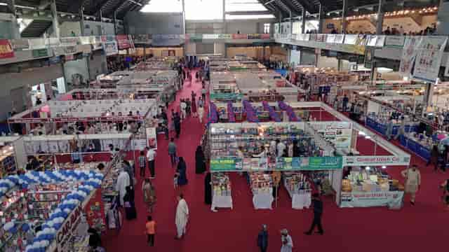 Lahore International Book Fair: bustling exhibition hall with vibrant vendor displays.