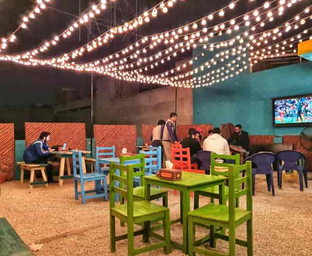 Rooftop terrace at Poet Boutique Restaurants, colorful chairs for networking events.