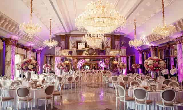 Elegant wedding hall with opulent chandeliers and romantic lighting at Hamara Venue.