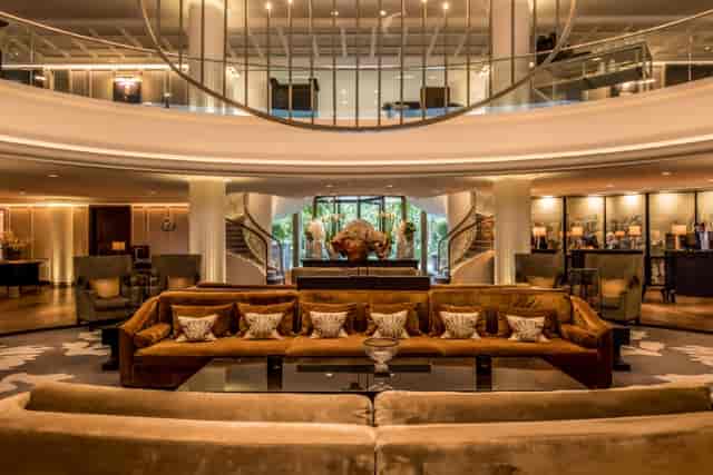 Sophisticated Sofitel Frankfurt lobby with plush seating for corporate meetings and events.
