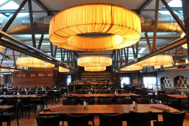 Spacious Depot 1899 restaurant with oversized chandeliers, ideal for corporate events.