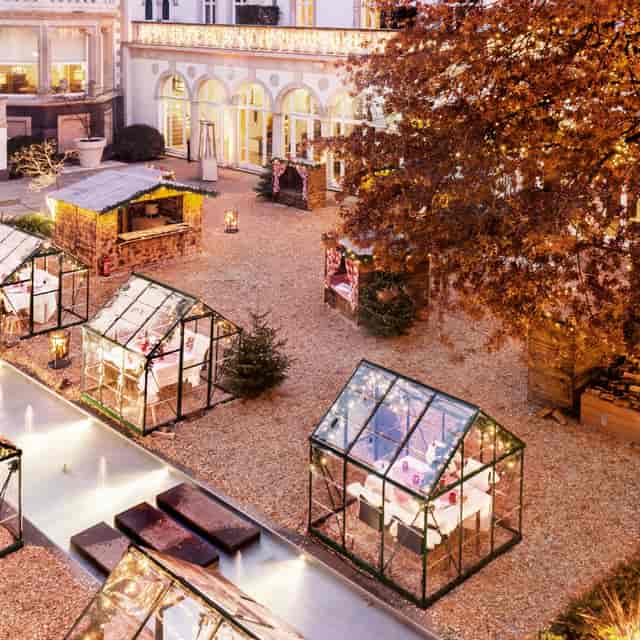 Outdoor event space at Kennedy's Restaurant with festive glass greenhouses, ideal for winter markets.