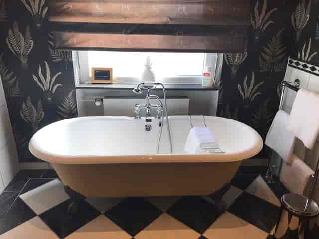 Luxurious freestanding bathtub in Villa Orange lobby, ideal for upscale wellness retreats.