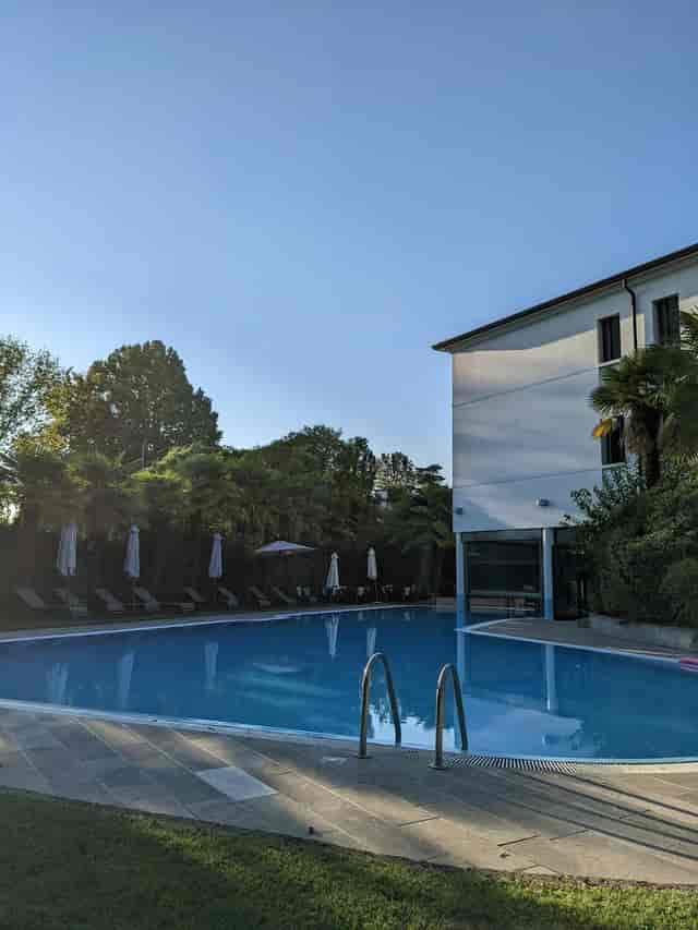 Serene poolside setting at Villa Pace Park Hotel, ideal for outdoor events and meetings.