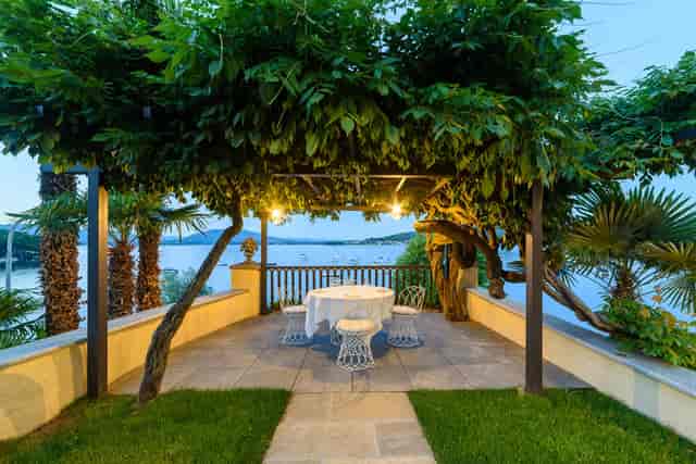 "Outdoor event space at Hotel Villa Paradiso with pergola, ideal for corporate retreats and gatherings."